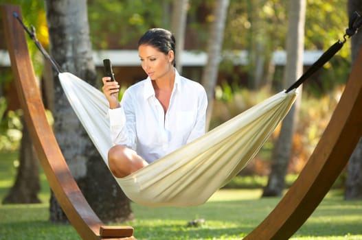 20-25 years woman portrait ralaxing on hammock at exotic surrounding, bali indonesia