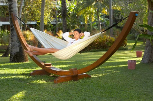 20-25 years woman portrait ralaxing on hammock at exotic surrounding, bali indonesia