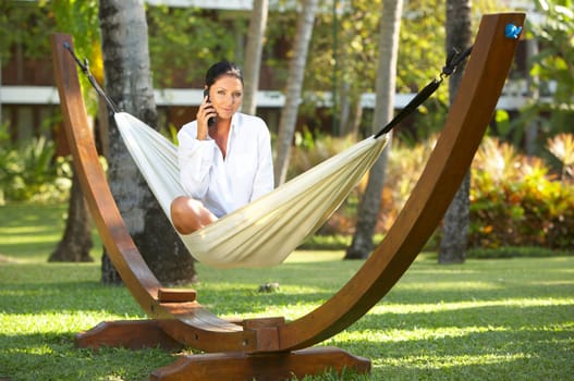 20-25 years woman portrait ralaxing on hammock at exotic surrounding, bali indonesia