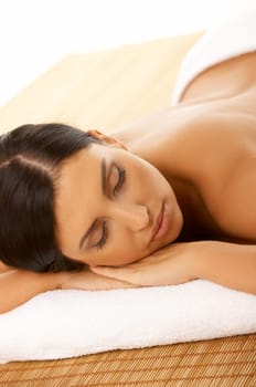 Portrait of Fresh and Beautiful brunette woman laying on bamboo mat