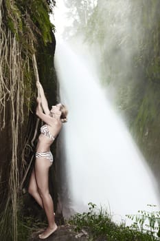 Beaurtiful woman posing near the Blawan waterfall
