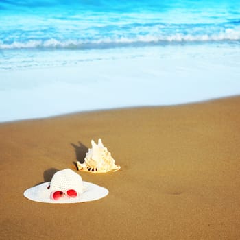 Hat, tube and sunglasses on the beach