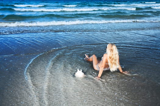 Young woman in bikini at the tropical beach