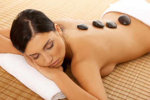 Portrait of Fresh and Beautiful brunette woman taking stone therapy