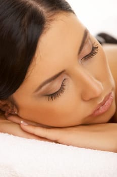 Portrait of Fresh and Beautiful brunette woman taking stone therapy