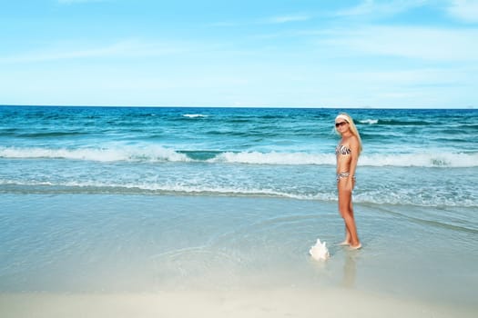 Young woman in bikini at the tropical beach