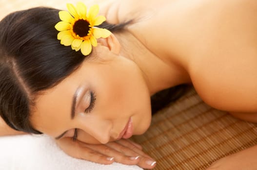 Portrait of Fresh and Beautiful brunette woman laying on bamboo mat