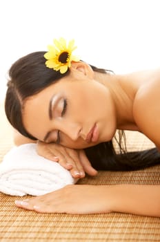Portrait of Fresh and Beautiful brunette woman laying on bamboo mat