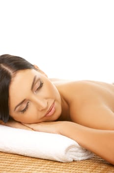 Portrait of Fresh and Beautiful brunette woman laying on bamboo mat