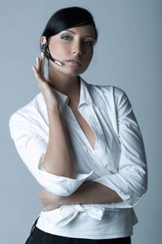 Beautiful brunette business woman with wireless headset isolated on clear background