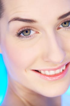 Portrait of 20-25 years old beautiful woman on blue background