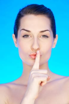 Portrait of 20-25 years old beautiful woman making quiet gesture