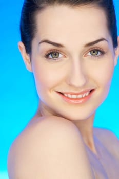 Portrait of 20-25 years old beautiful woman on blue background