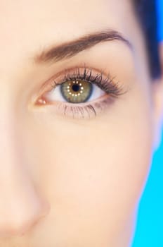 Part of beautiful face of a woman with on blue background