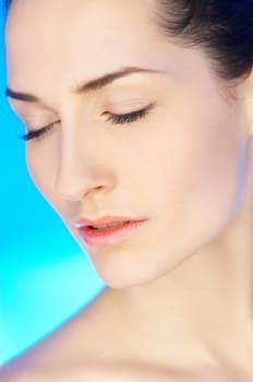 Portrait of 20-25 years old beautiful woman on blue background