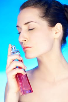 Portrait of 20-25 years old beautiful woman with bottle of perfume