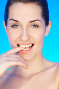 Portrait of 20-25 years old beautiful woman on blue background
