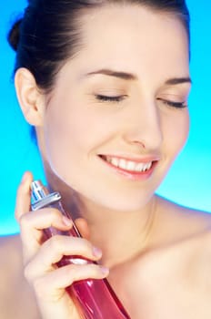 Portrait of 20-25 years old beautiful woman with bottle of perfume