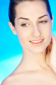 Portrait of 20-25 years old beautiful woman on blue background
