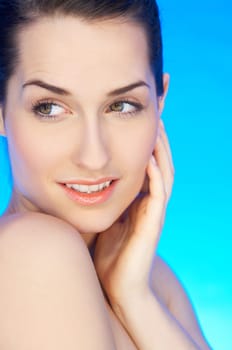 Portrait of 20-25 years old beautiful woman on blue background