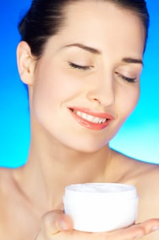 Portrait of 20-25 years old beautiful woman with cream