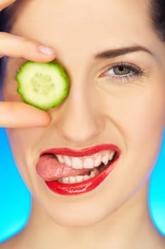 Portrait of beautiful woman with cucumber slice