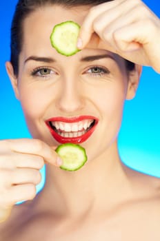 Portrait of beautiful woman with cucumber slice