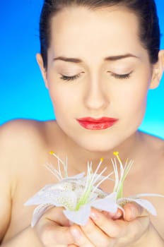 Portrait of beautiful woman holding flowers in hands