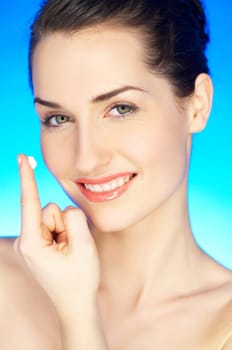 Portrait of 20-25 years old beautiful woman with cream