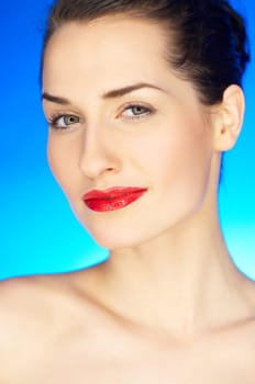 Portrait of 20-25 years old beautiful woman on blue background