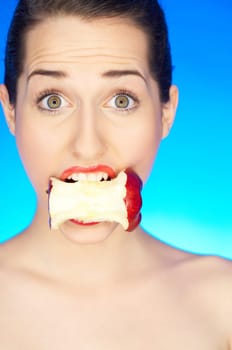 Portrait of beautiful woman with apple core in mouth
