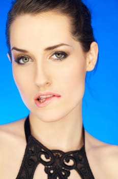 Portrait of beautiful woman bites her lip