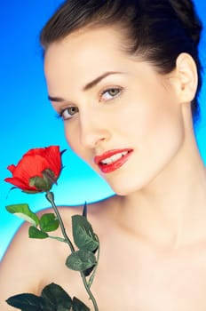 Portrait of beautiful woman with red rose