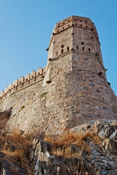 vertical portrait of a watch tower Kumbhalghar Fort Rajasthan India showing ninth century architecture