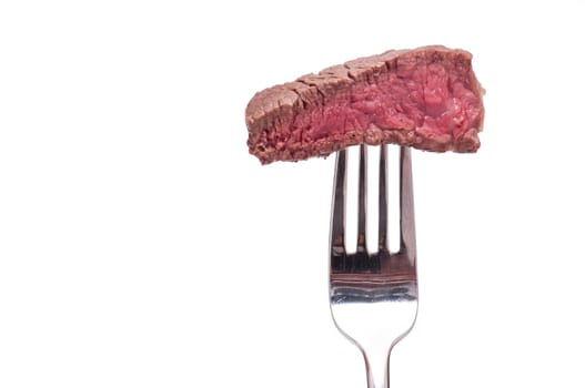 Pink roasted beef on a fork white isolated