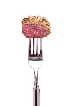 White cut out lamb with mustard crust on a fork