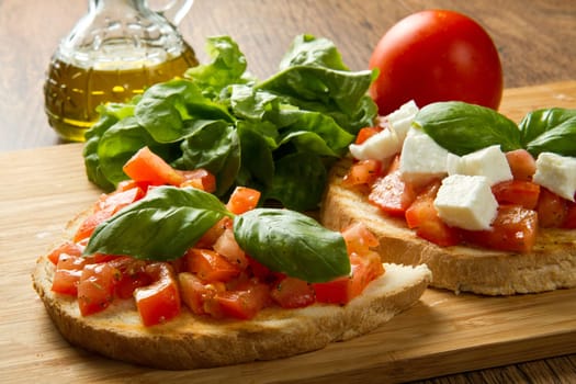 italian bruschetta with fresh tomatoes, basil, garlic, olive oil and cheese