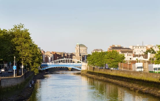 Dublin city at sunset - view over the Rory O&#039 More and James Joyce&#039 s bridges and the Four Courts. On the Liffey river.