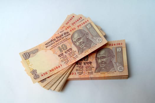 Stack of Indian currency notes of ten rupee denomination bearing Mahatma Gandhi's portrait
