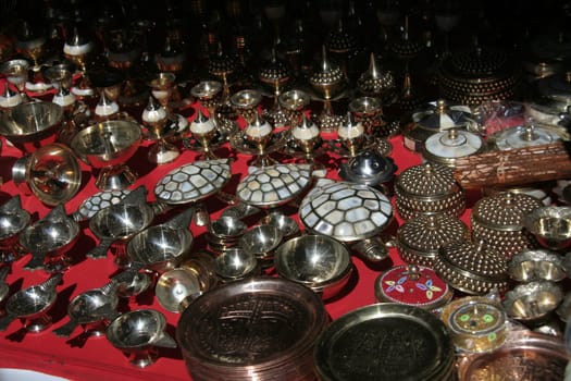 Merchandise in stalls displaying glittering metal articles
