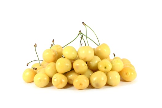 Heap of yellow cherry isolated on white