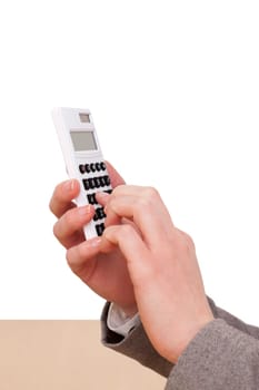 Woman's hand operating a calculator