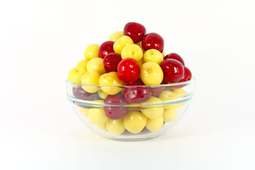 Red and yellow cherries isolated on white