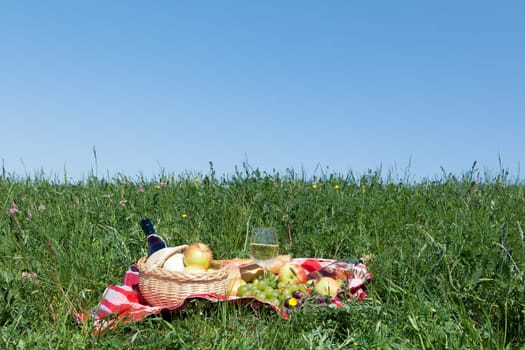 Outdoor picnic,tablecloth with snack on a meadow