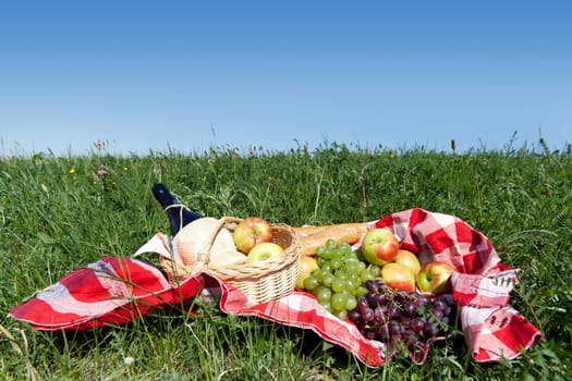 Outdoor picnic,tablecloth with snack on a meadow