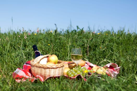 Outdoor picnic,tablecloth with snack on a meadow