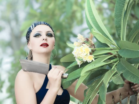 Woman in garden cut flowers with a knife