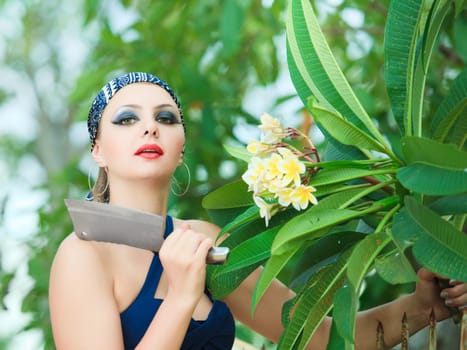 Woman in garden cut flowers with a knife