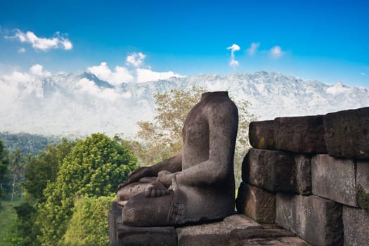 Buddha statue? mountain on background. Borobudur. Java. Indonesia