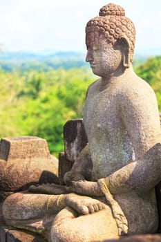 Buddha statue. Mountain on background. Borobudur. Java. Indonesia